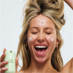 Alix Earle holding Dew More Reale Actives Product in hand smiling